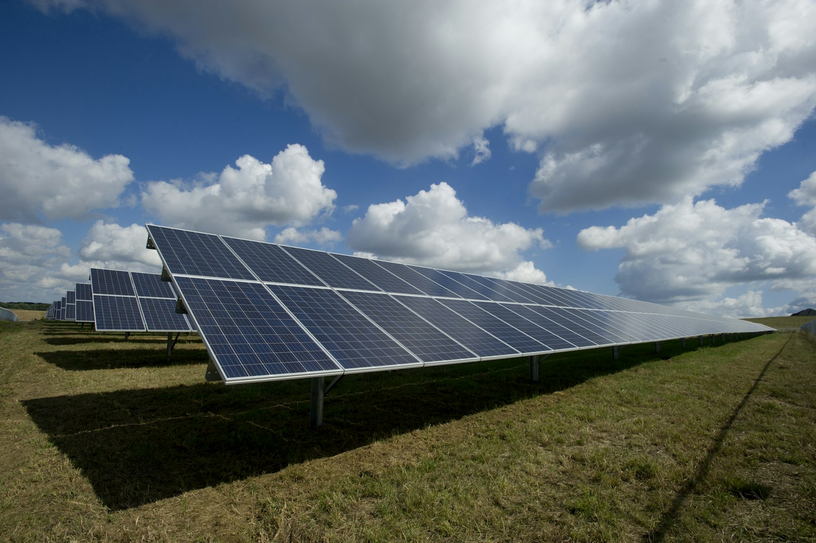 Solar panels with green mountains in the background in rural Spain